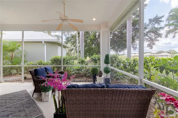 a view of a dining room with furniture and garden view