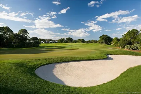 a view of a golf course with a lake view