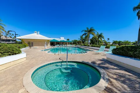 a swimming pool with outdoor seating yard and barbeque oven