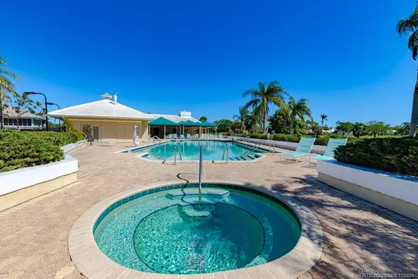 a swimming pool with outdoor seating yard and barbeque oven