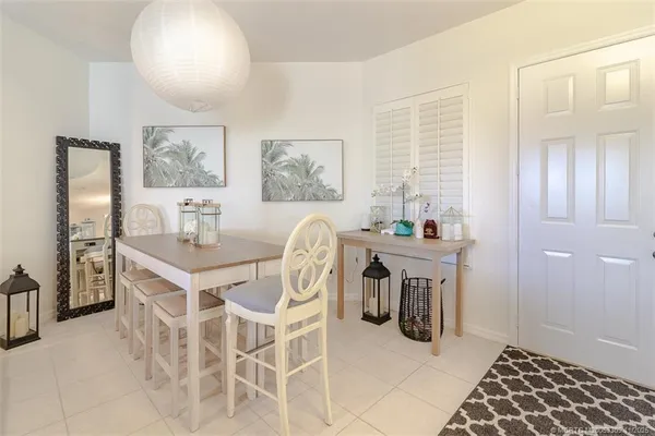 a dining room with furniture and window