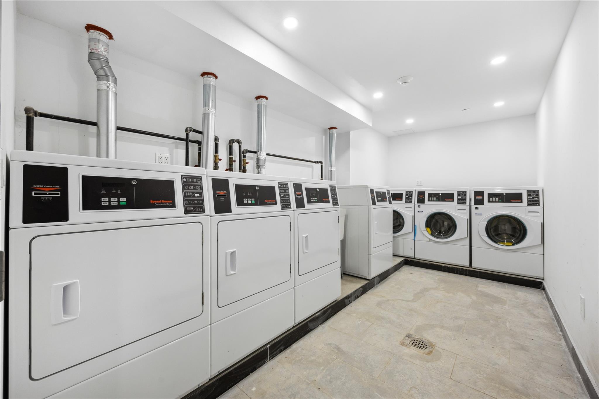 163-07 72nd Avenue, Unit 2C Queens, NY 11365 - Photo 14 of 14 Shared laundry area with baseboards, washer and clothes dryer, and recessed lighting