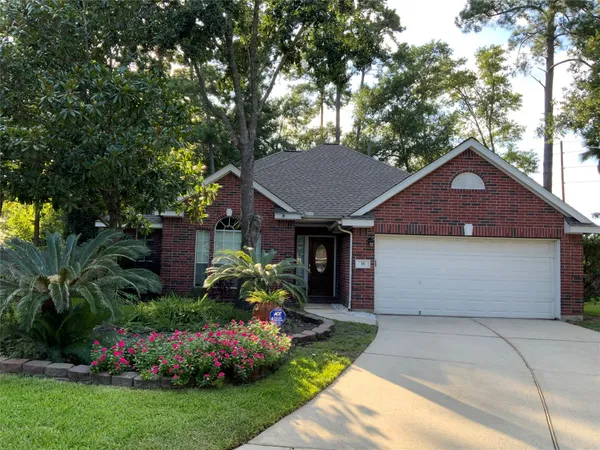 a front view of a house with a garden and plants
