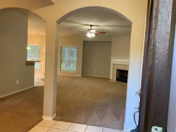 a kitchen with granite countertop a refrigerator stove and microwave