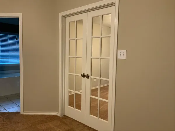 an empty room with closet and a bathroom