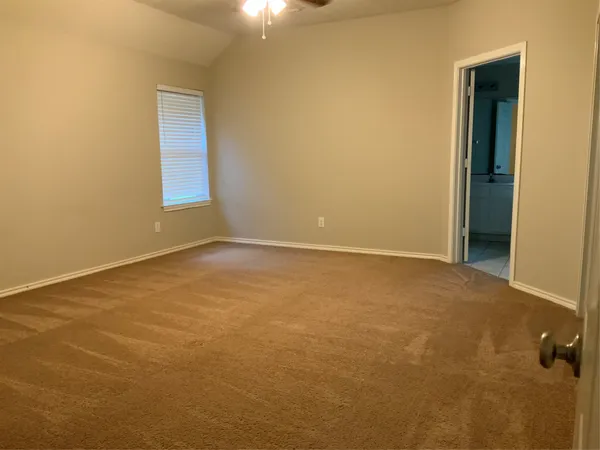 a view of an empty room with a window