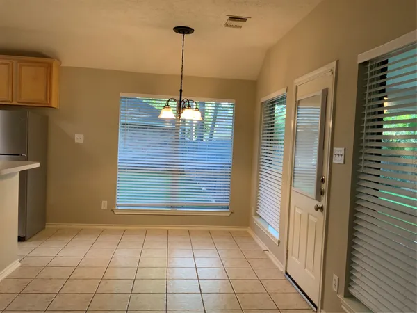 a view of an empty room with a fireplace and a window