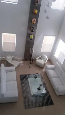 a living room with furniture and next to a window