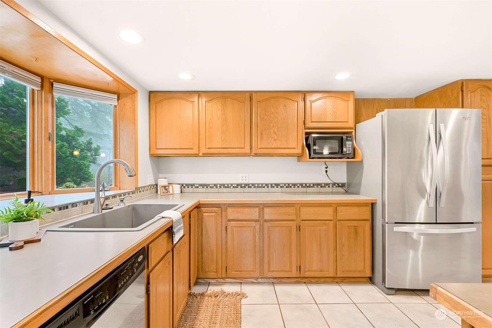 2400 View Ridge Drive Bellingham, WA 98229 - Photo 12 of 39 a kitchen with a refrigerator a sink and cabinets