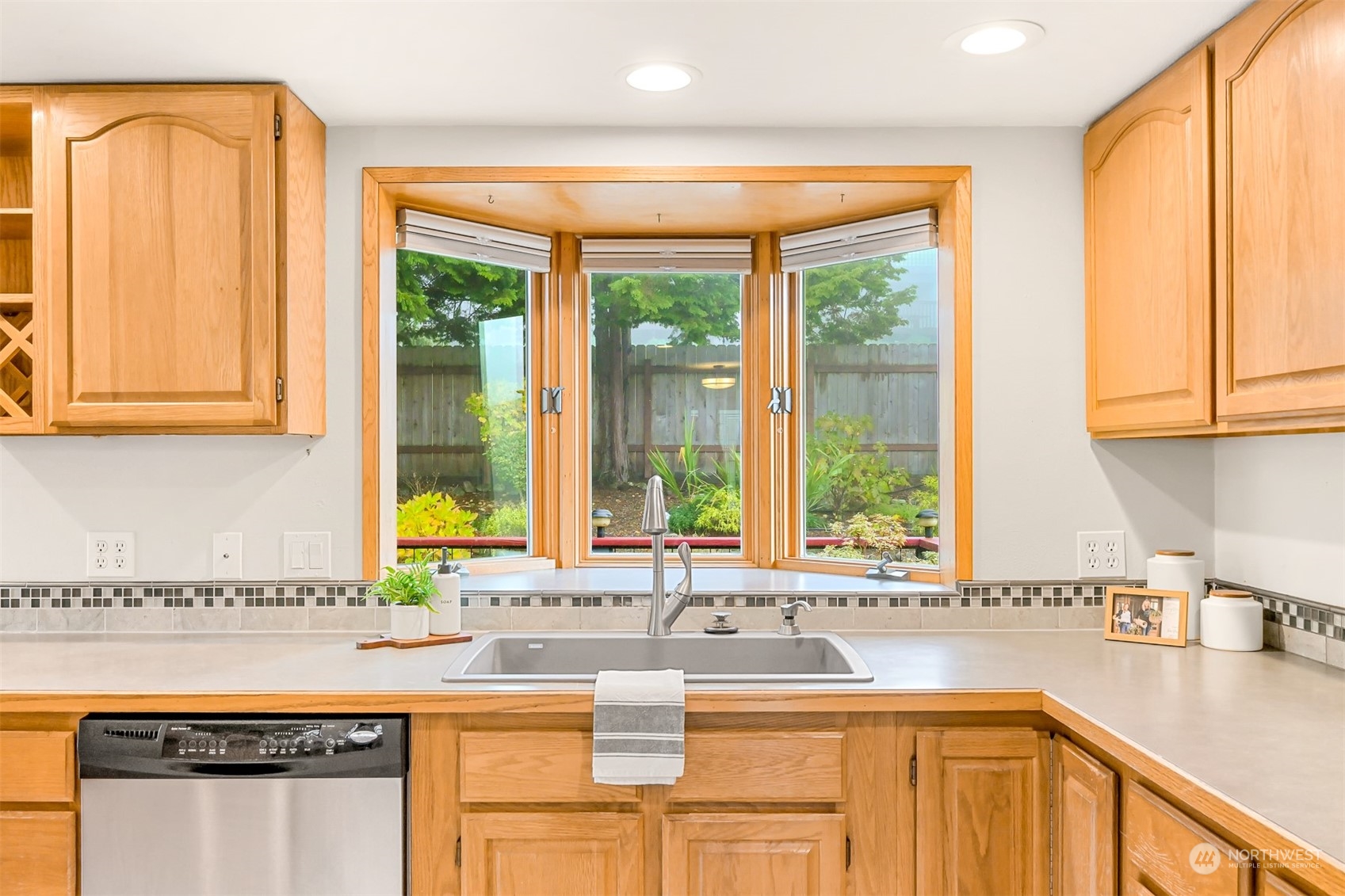 2400 View Ridge Drive Bellingham, WA 98229 - Photo 14 of 39 a kitchen with stainless steel appliances granite countertop a sink a stove and a cabinets next to a window