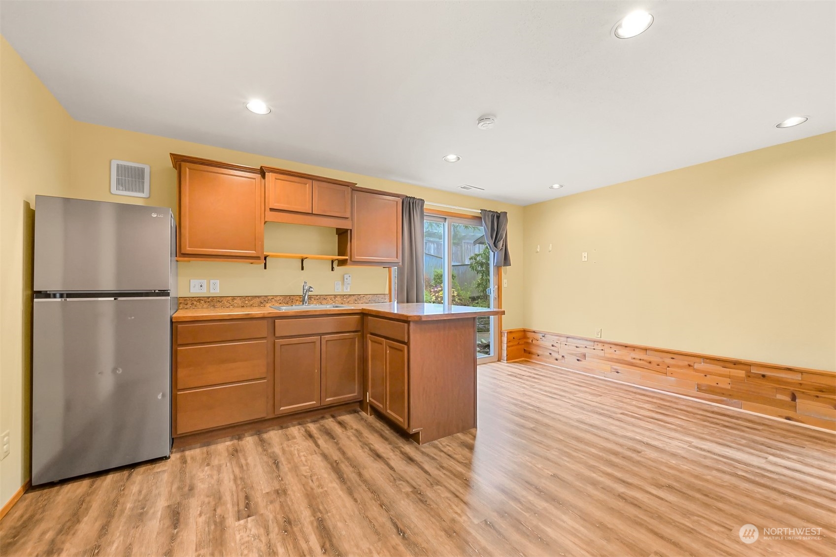 2400 View Ridge Drive Bellingham, WA 98229 - Photo 27 of 39 a kitchen with a refrigerator and wooden floor