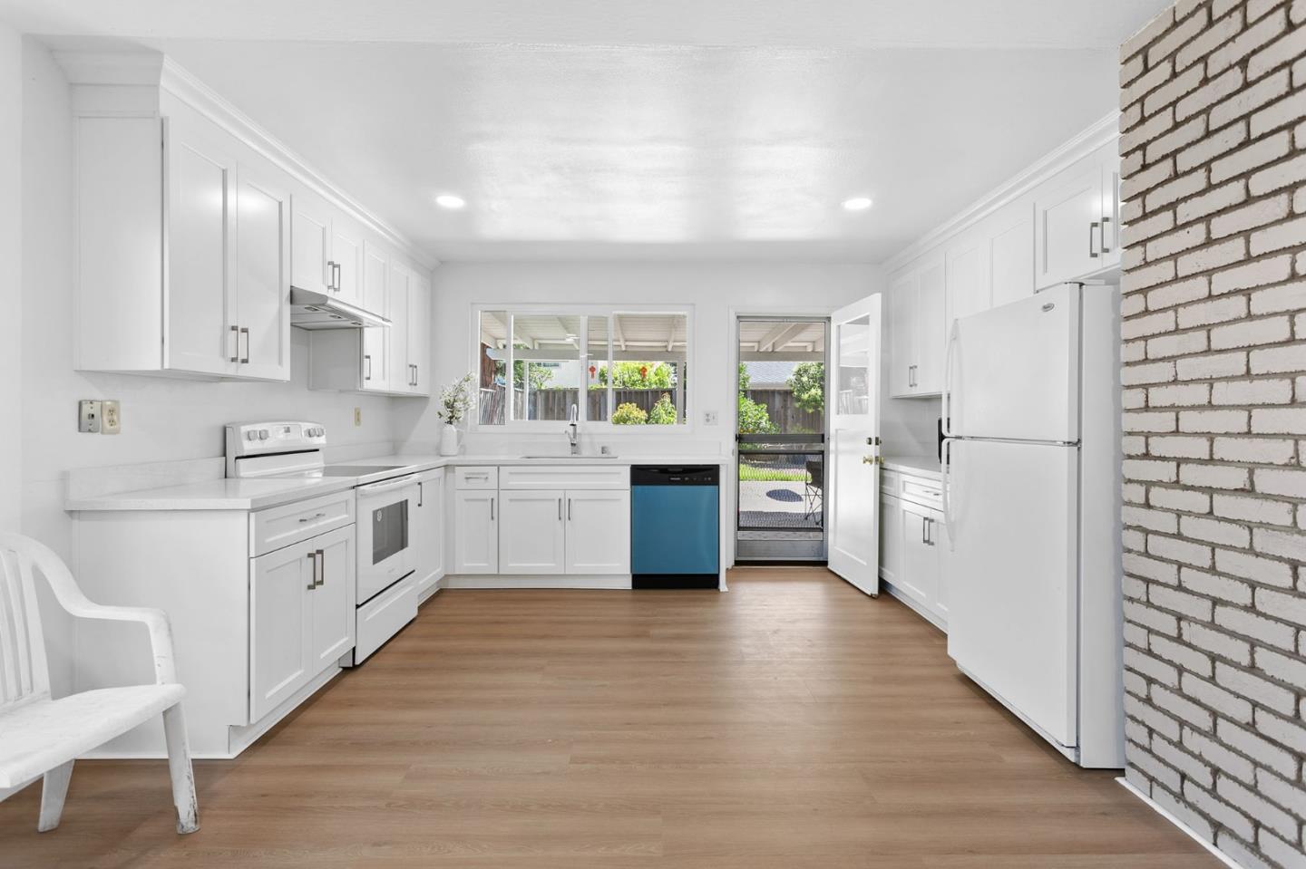 2962 Tuers Road San Jose, CA 95121 - Photo 13 of 38 a kitchen with white cabinets and white appliances
