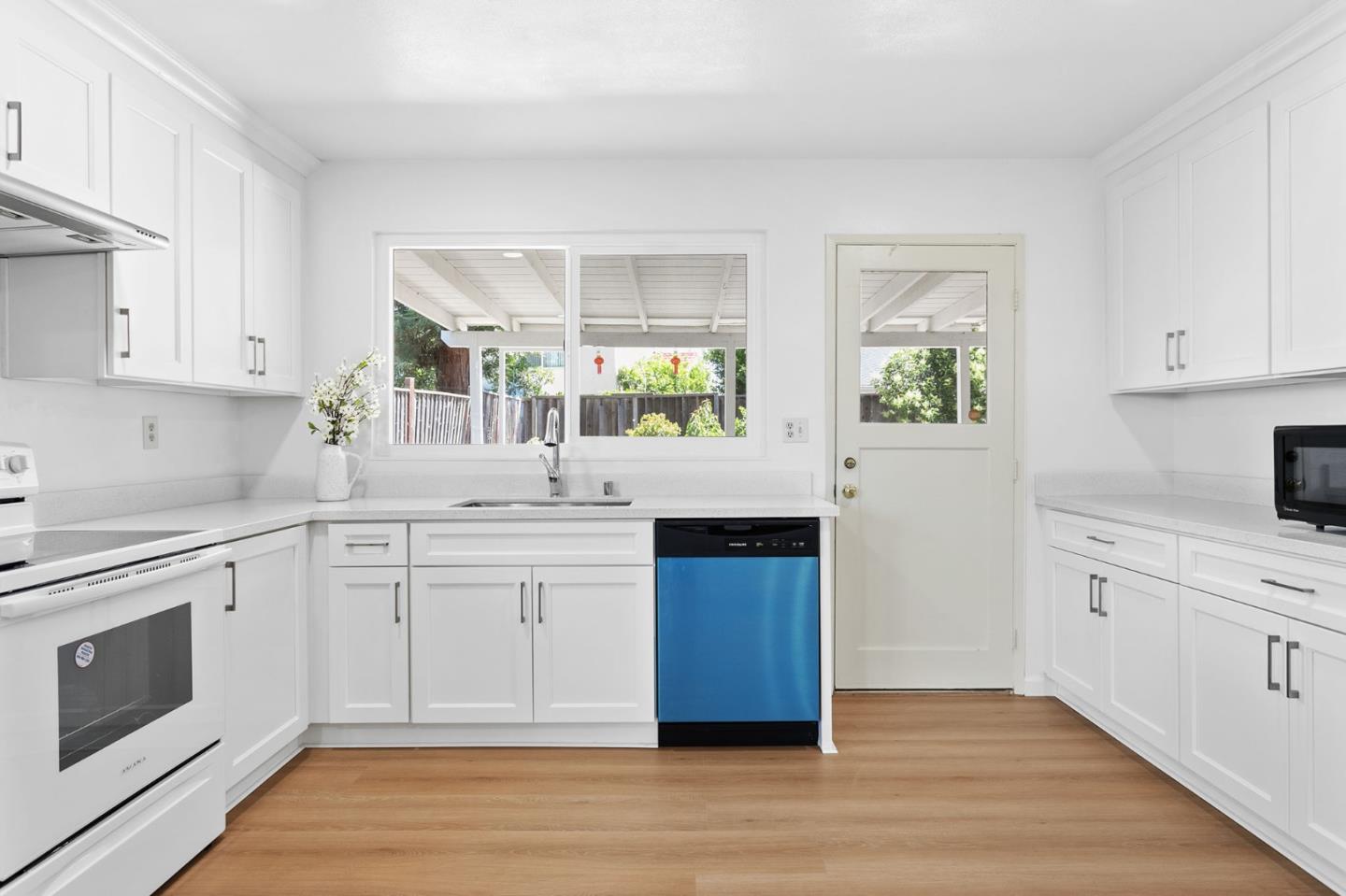 2962 Tuers Road San Jose, CA 95121 - Photo 14 of 38 a kitchen with granite countertop a sink cabinets stainless steel appliances and a window