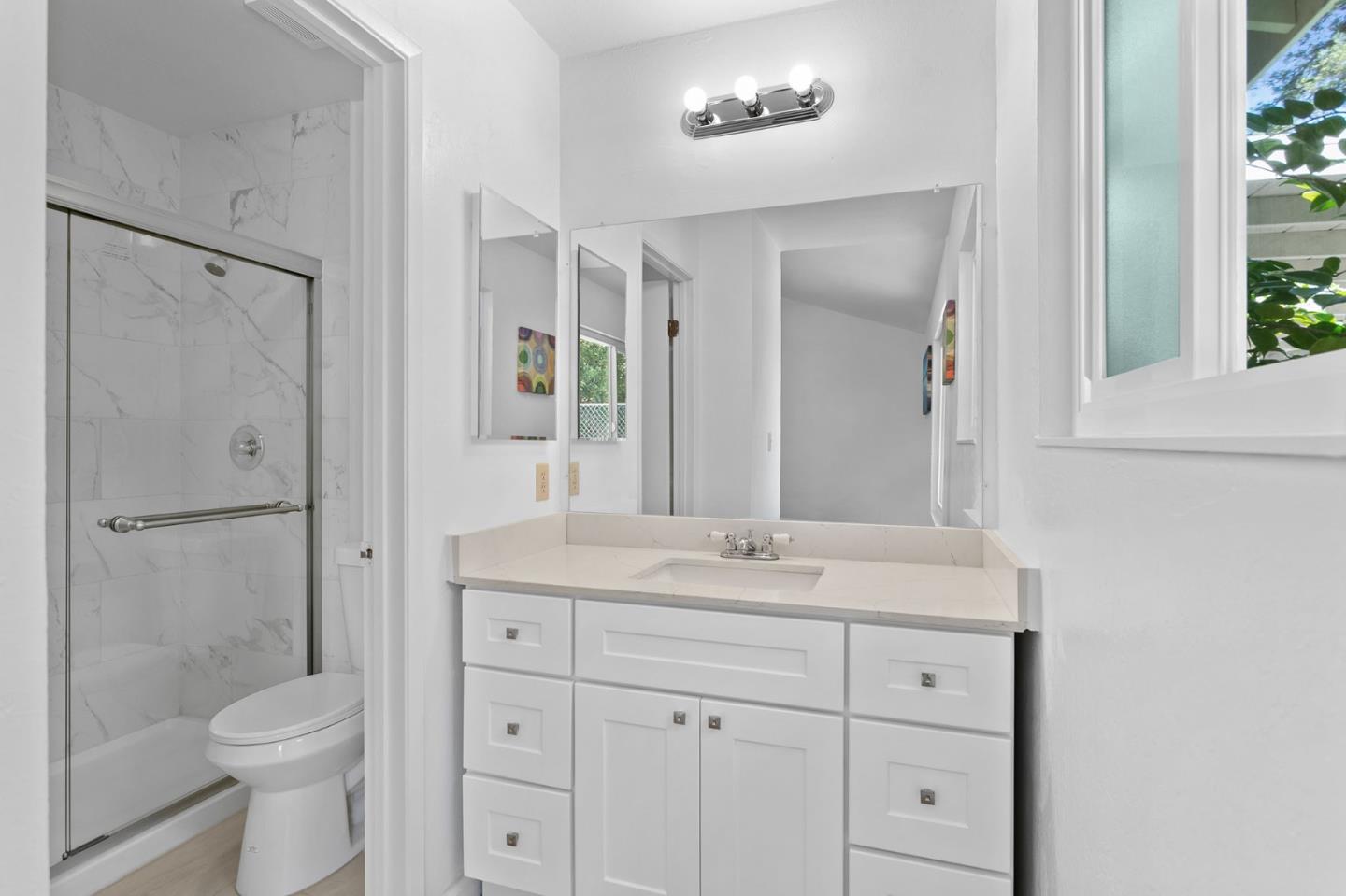 2962 Tuers Road San Jose, CA 95121 - Photo 23 of 38 a bathroom with a granite countertop sink toilet a large mirror a vanity and shower