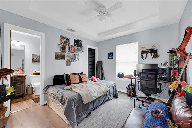a bedroom with a bed and wooden floor