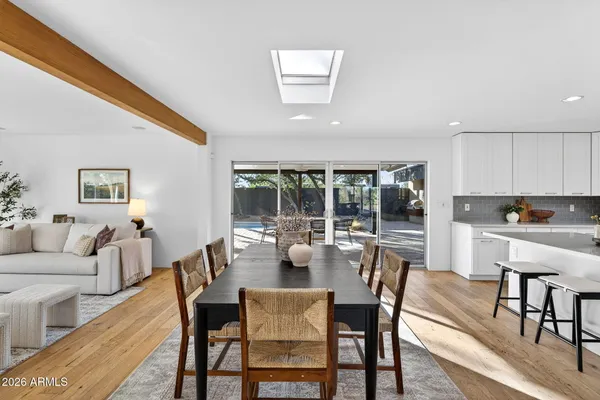 a view of a dining room with furniture large windows and wooden floor