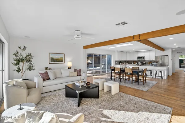 a living room with furniture and view of kitchen