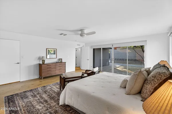 a bedroom with a bed and wooden floor