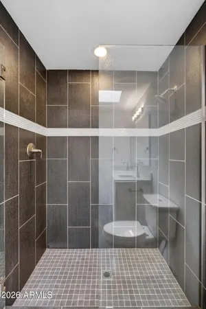 a bathroom with a glass door shower