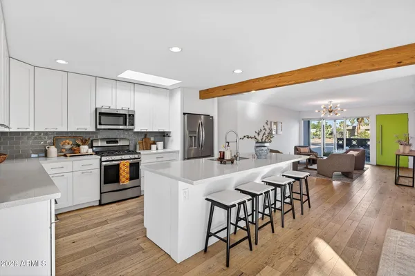 a large kitchen with a table and chairs