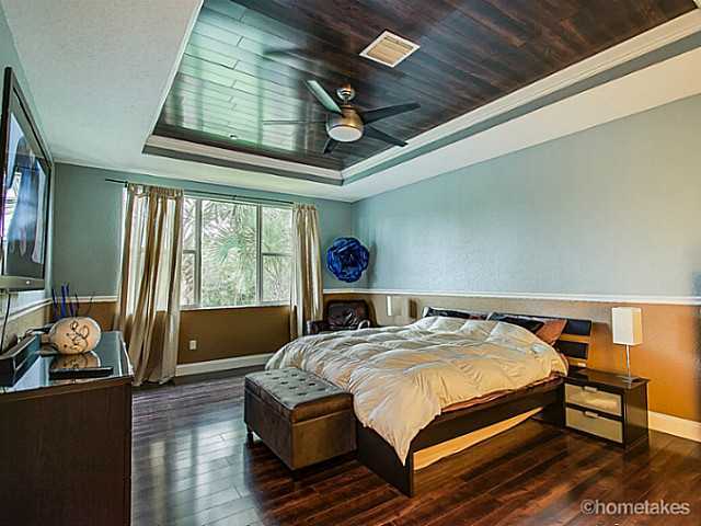 358 Southwest Walking Path Stuart, FL 34997 - Photo 11 of 22 a bedroom with a bed next to a window with outer view