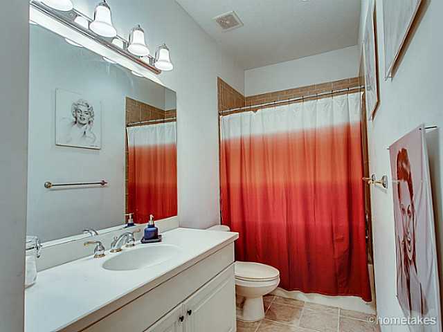 358 Southwest Walking Path Stuart, FL 34997 - Photo 16 of 22 a bathroom with a sink a toilet and a large mirror