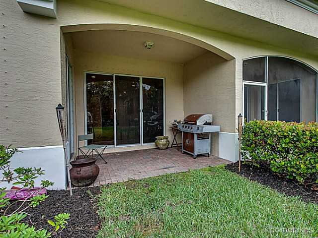 358 Southwest Walking Path Stuart, FL 34997 - Photo 17 of 22 a view of a chair and table in backyard of the house