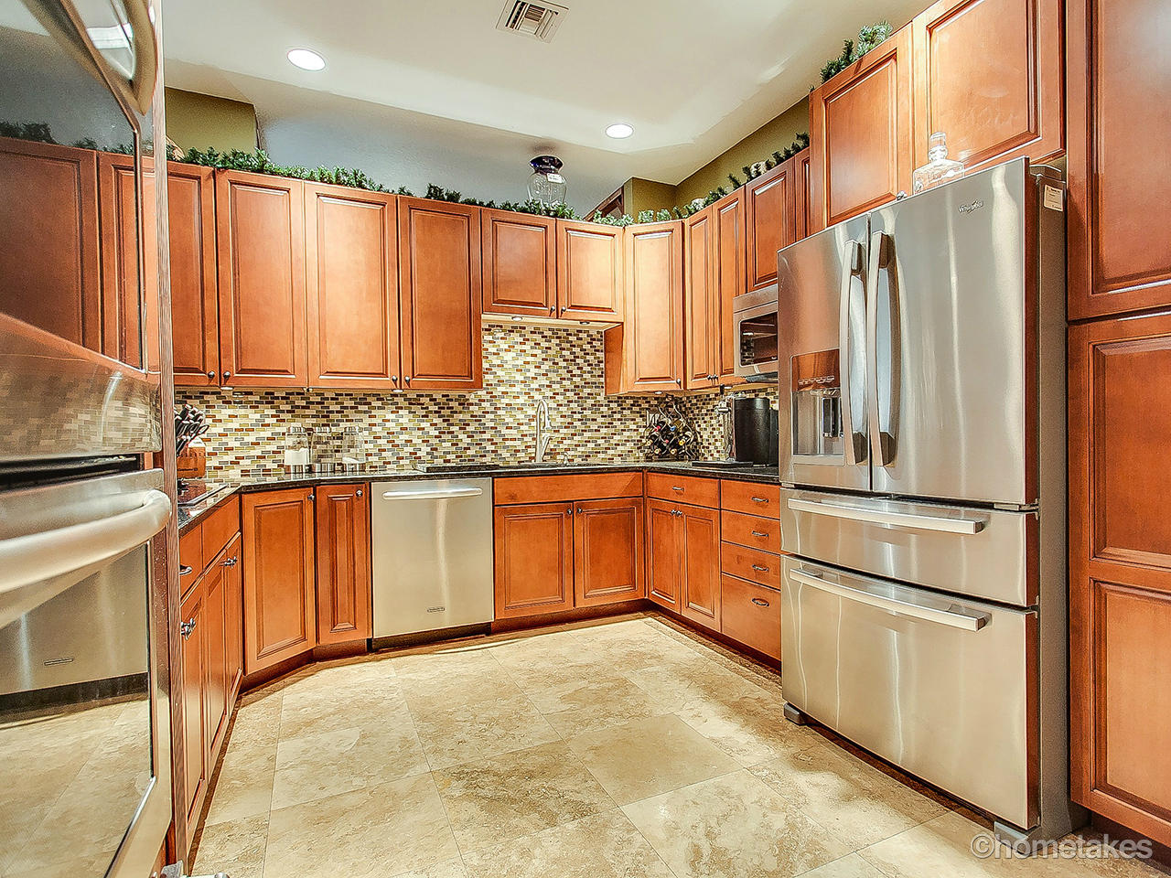 358 Southwest Walking Path Stuart, FL 34997 - Photo 2 of 22 a kitchen with stainless steel appliances granite countertop a refrigerator and a sink