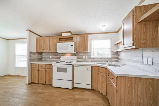 a kitchen with stainless steel appliances granite countertop a stove sink and cabinets