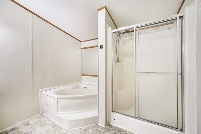 a bathroom with a tub and shower