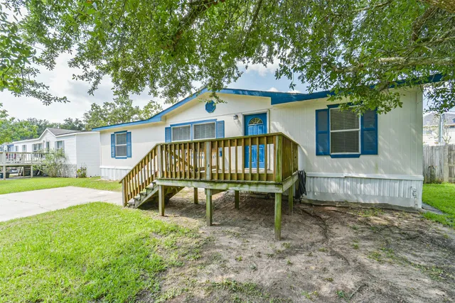 a view of a house with a yard and furniture