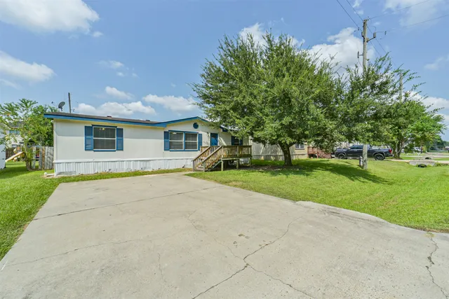 a view of house with outdoor space and garden