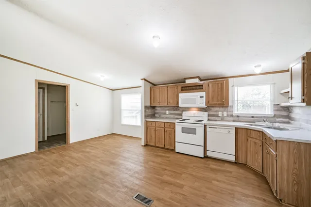 a large kitchen with a stove top oven sink and cabinets
