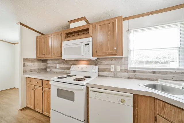 a kitchen with appliances cabinets and a sink
