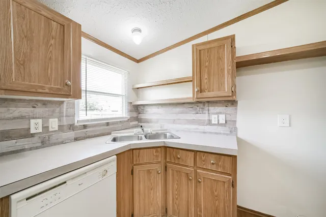 a kitchen with a sink cabinets and window