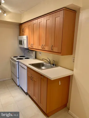 a utility room with a sink a washer and dryer