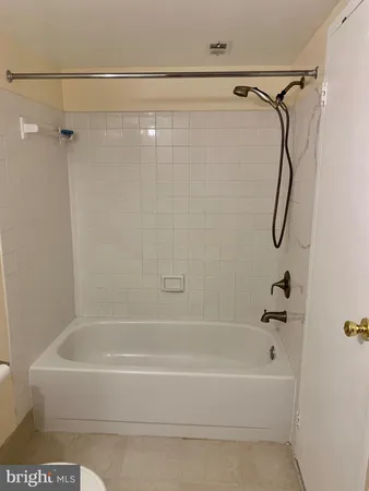 a bathroom with a bath tub with a shower