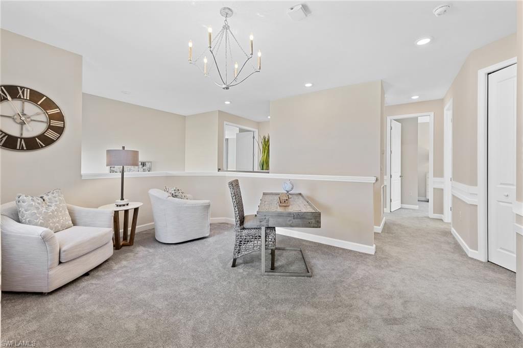 14351 Lagoon Lane Babcock Ranch, FL 33982 - Photo 23 of 39 a living room with furniture and a chandelier
