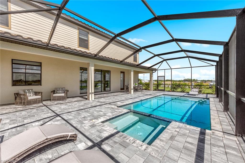 14351 Lagoon Lane Babcock Ranch, FL 33982 - Photo 38 of 39 a view of a patio with swimming pool table and chairs