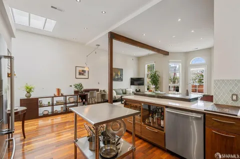 a large kitchen with a table and chairs