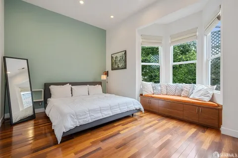 a bedroom with a bed and a large window
