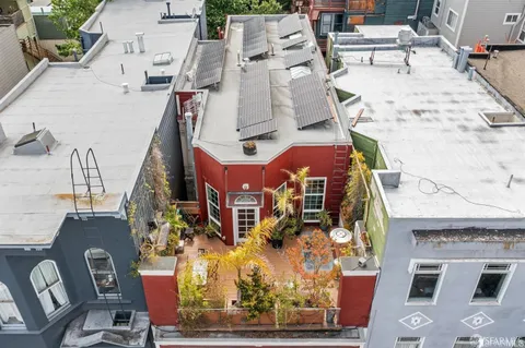 an aerial view of residential houses with outdoor space
