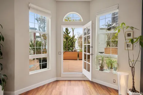 a view of an entryway with wooden floor and a window