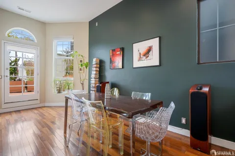 a view of a dining room with furniture and wooden floor
