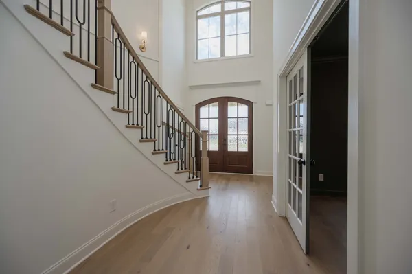 a large kitchen with stainless steel appliances kitchen island granite countertop a stove a refrigerator a sink dishwasher a oven and a dining table with wooden floor