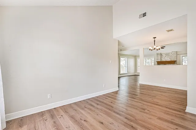 a view of a kitchen with wooden floor and a kitchen