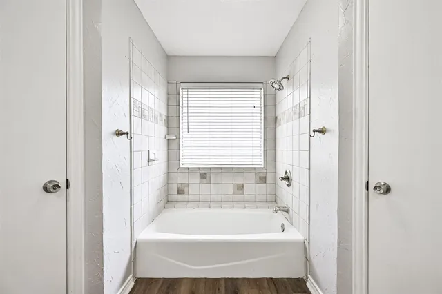 a bathroom with a tub and shower