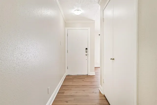 a view of a hallway with wooden floor