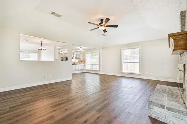 a view of a livingroom with a window and wooden floor