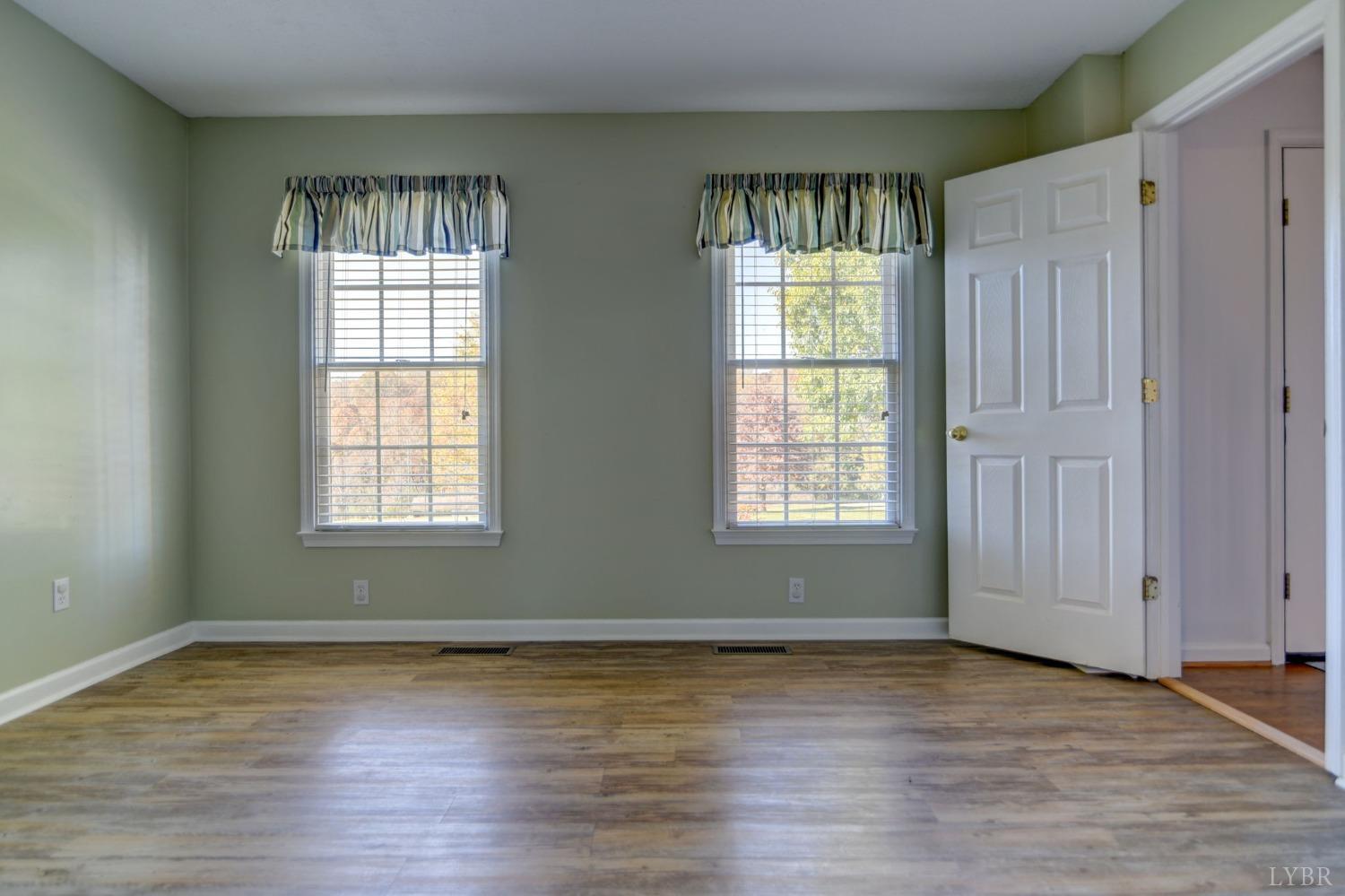3636 White Road Forest, VA 24551 - Photo 18 of 44 an empty room with wooden floor and windows